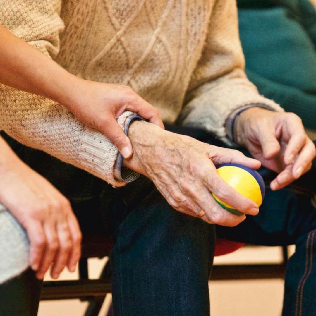 insurance-older couple talking on swing